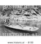 Historical Image of a Native American Indian Man in a Canoe on a River 1923 - Black and White by Al