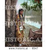 Historical Photo of Young Native American Indian Girl Posing Against a Tree Beside a Boat on a River Bank 1904 by Al