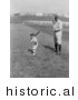 Historical Photo of Babe Ruth and a Boy, Little Mascot, Posing with Bats on a Baseball Field - Black and White Version by Picsburg