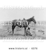 Historical Photo of a Cowboy Sitting Beside His Saddled Horse on a Hill, Overlooking Horses in Bonham, Texas, 1910 - Black and White Version by Al
